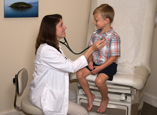 A doctor measures a child's heart rate